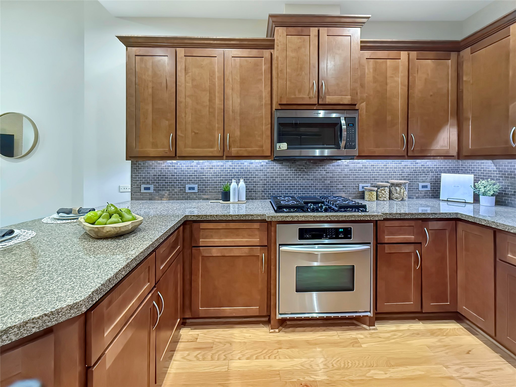 3 Waterway Court, Unit 2B Spring, TX 77380 - Photo 15 of 46 a kitchen with granite countertop stainless steel appliances a stove a sink and a microwave