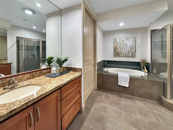 a bathroom with a granite countertop sink mirror and toilet