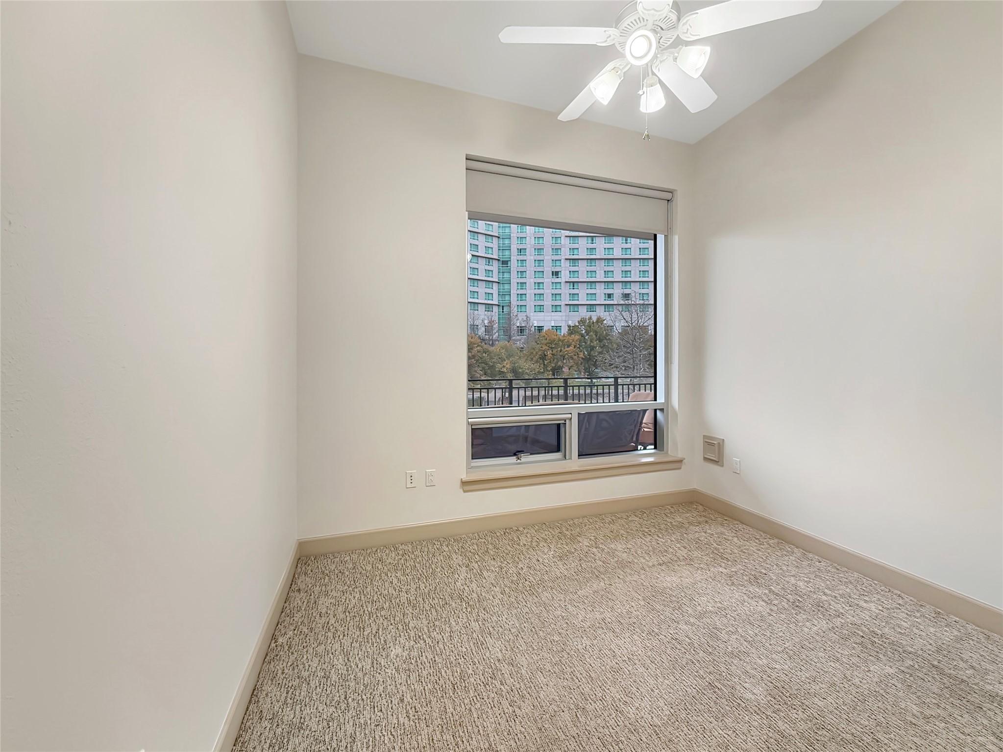 3 Waterway Court, Unit 2B Spring, TX 77380 - Photo 25 of 46 an empty room with a chandelier fan and windows