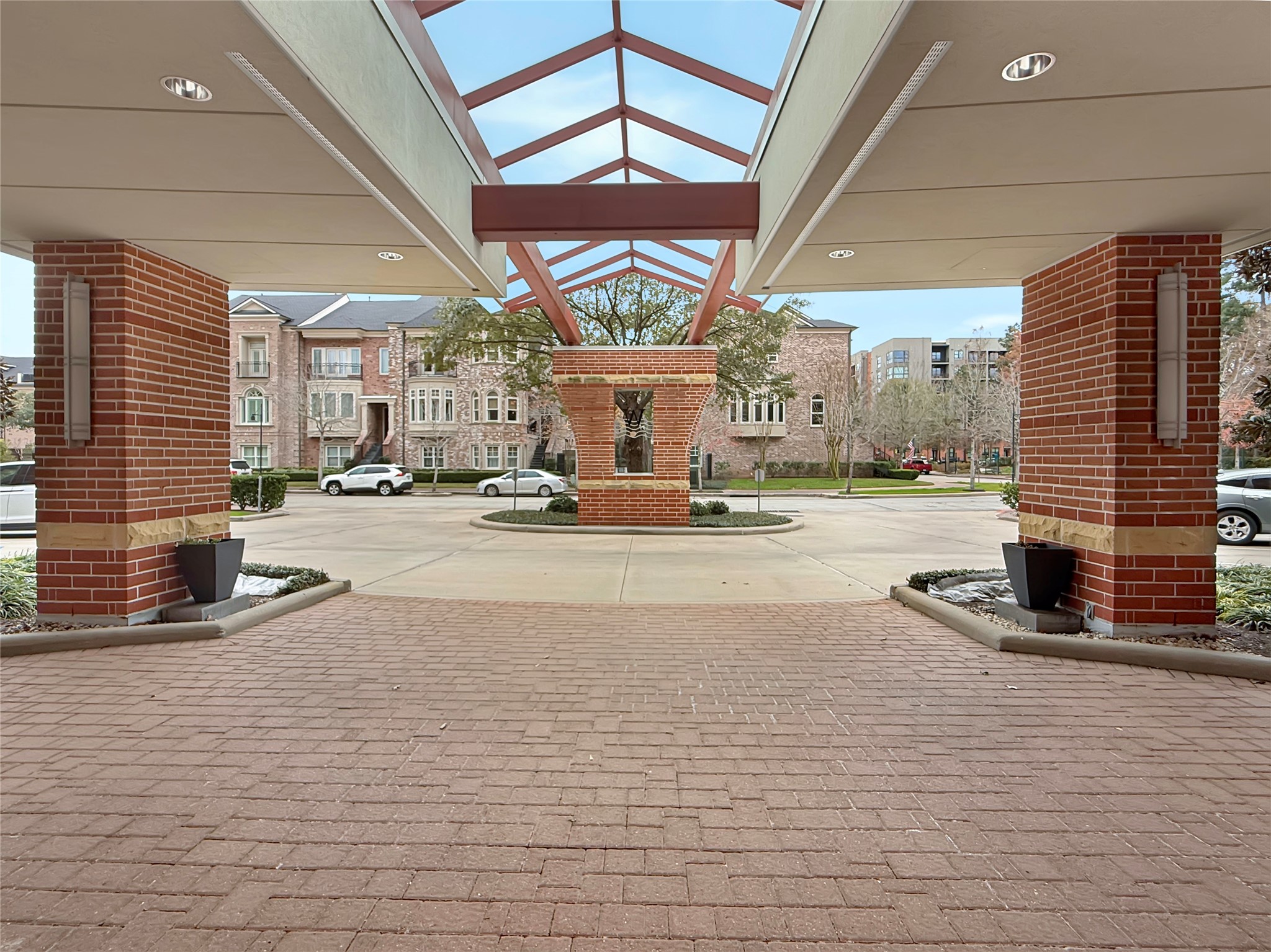 3 Waterway Court, Unit 2B Spring, TX 77380 - Photo 41 of 46 Outside Front Entry with Circular drive and guest parking at the front of the building. Gated entrance to the underground garage is to the left