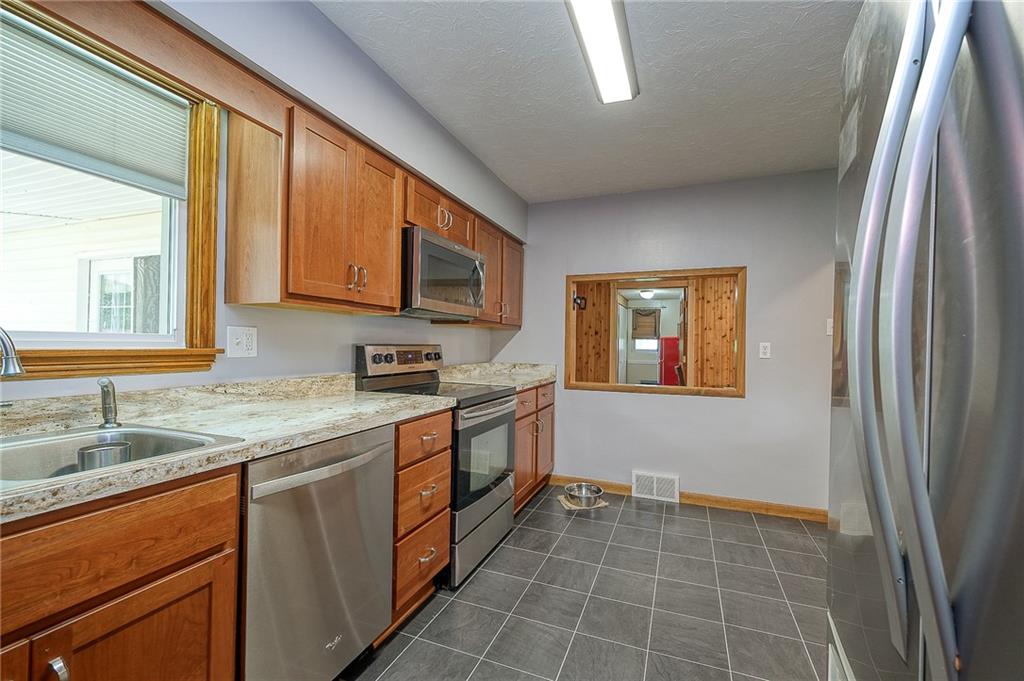 4100 Tuscarawas Road Beaver, PA 15009 - Photo 5 of 34 a kitchen with a sink stove and microwave