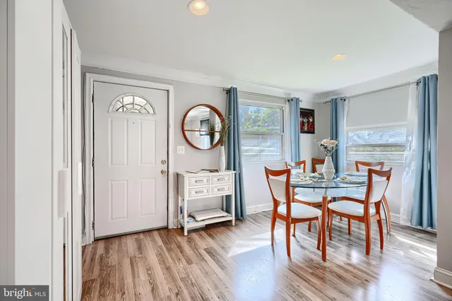 a living room with furniture and view of kitchen