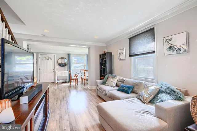 a kitchen with stainless steel appliances kitchen island granite countertop a refrigerator a stove and a sink