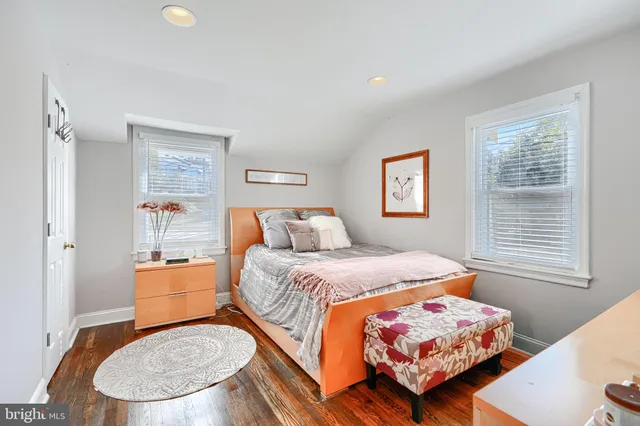 a bedroom with a bed and a wooden floor