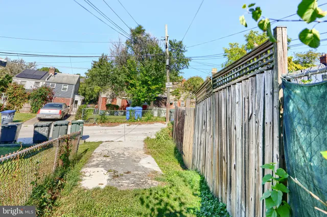 a view of a house with a wooden fence