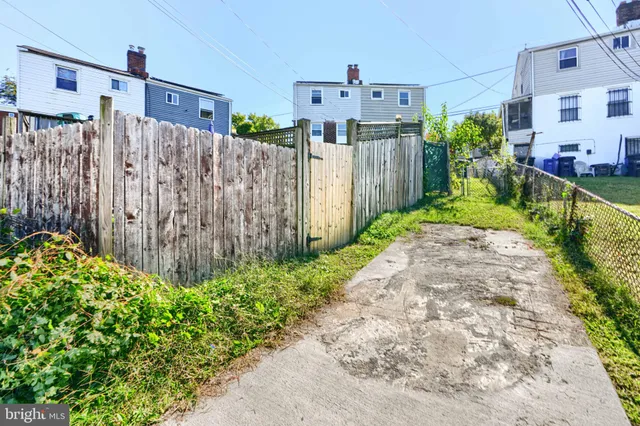 a view of a house with a wooden fence