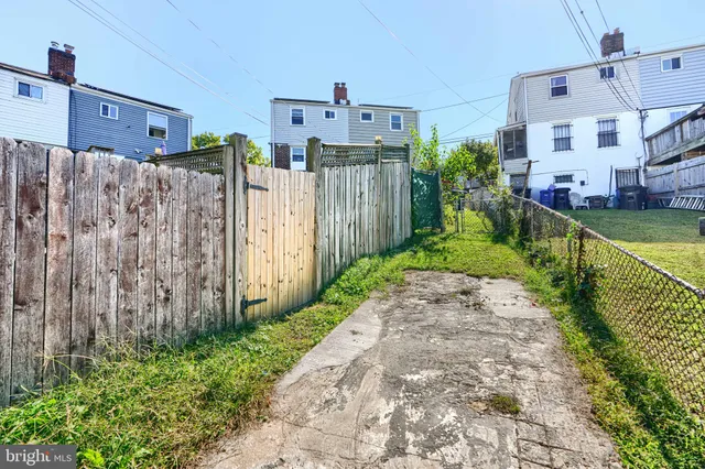 a view of a house with backyard sitting area and garden