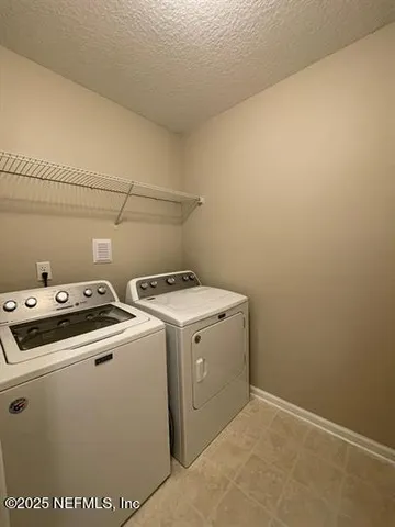 a view of storage and utility room with washer and dryer