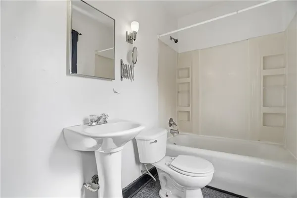 a bathroom with a sink toilet mirror and shower