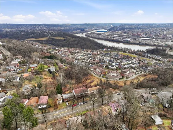 an aerial view of residential building and lake