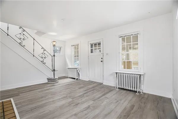 a view of an entryway with wooden floor