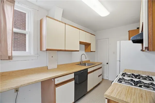 a kitchen with a sink stove and cabinets