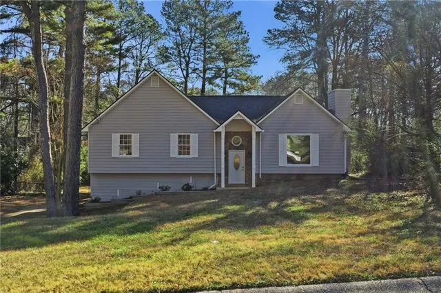 a view of a house with a yard patio and fire pit