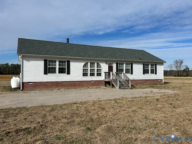 View of front of home featuring roof with shingles
