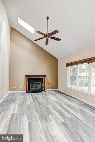 a view of a livingroom with a ceiling fan and window