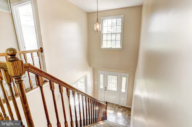 a view of a hallway with windows and stairs