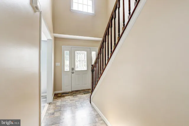 a view of a livingroom with wooden floor and stairs
