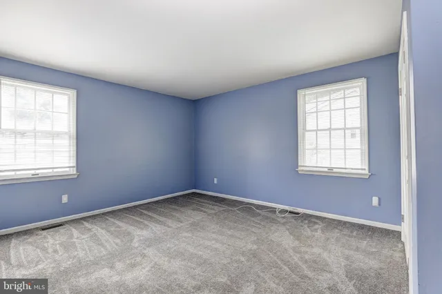 a view of empty room with wooden walls