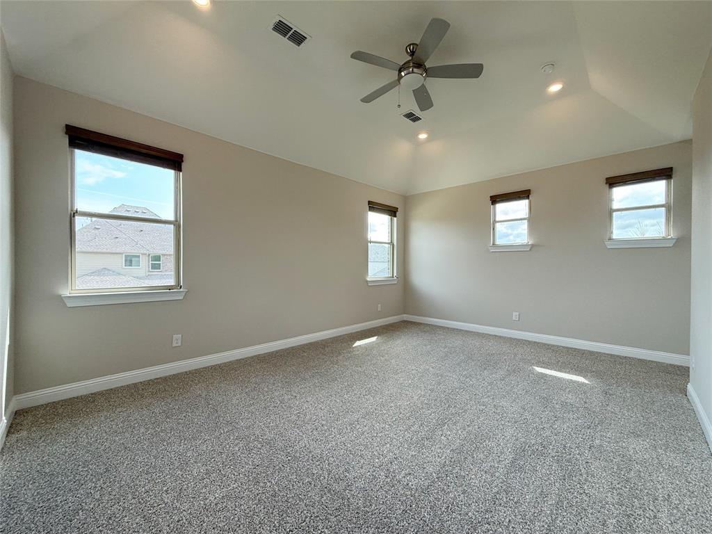 9829 Sharps Road Frisco, TX 75035 - Photo 19 of 40 Unfurnished room with carpet floors, recessed lighting, a ceiling fan, and vaulted ceiling