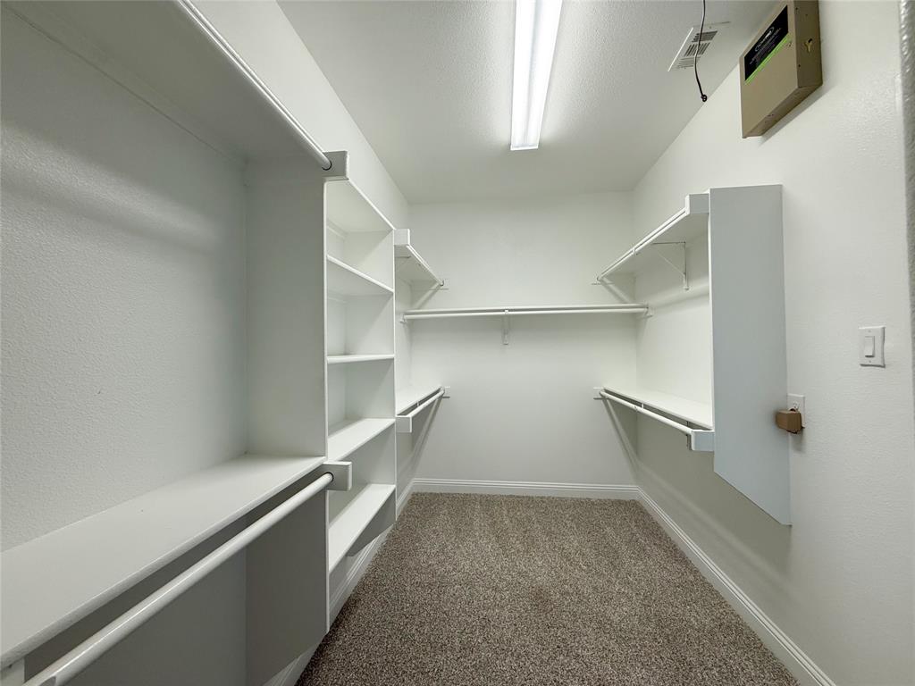 9829 Sharps Road Frisco, TX 75035 - Photo 23 of 40 Walk in closet with dark colored carpet