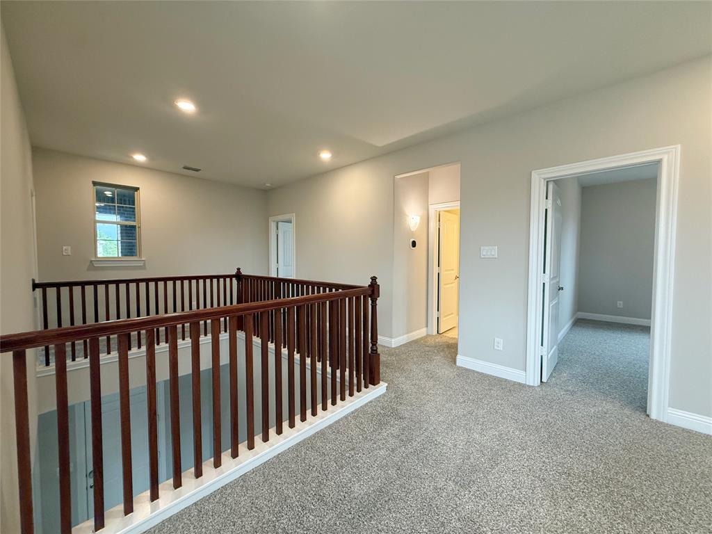 9829 Sharps Road Frisco, TX 75035 - Photo 27 of 40 Corridor with light carpet, an upstairs landing, and recessed lighting