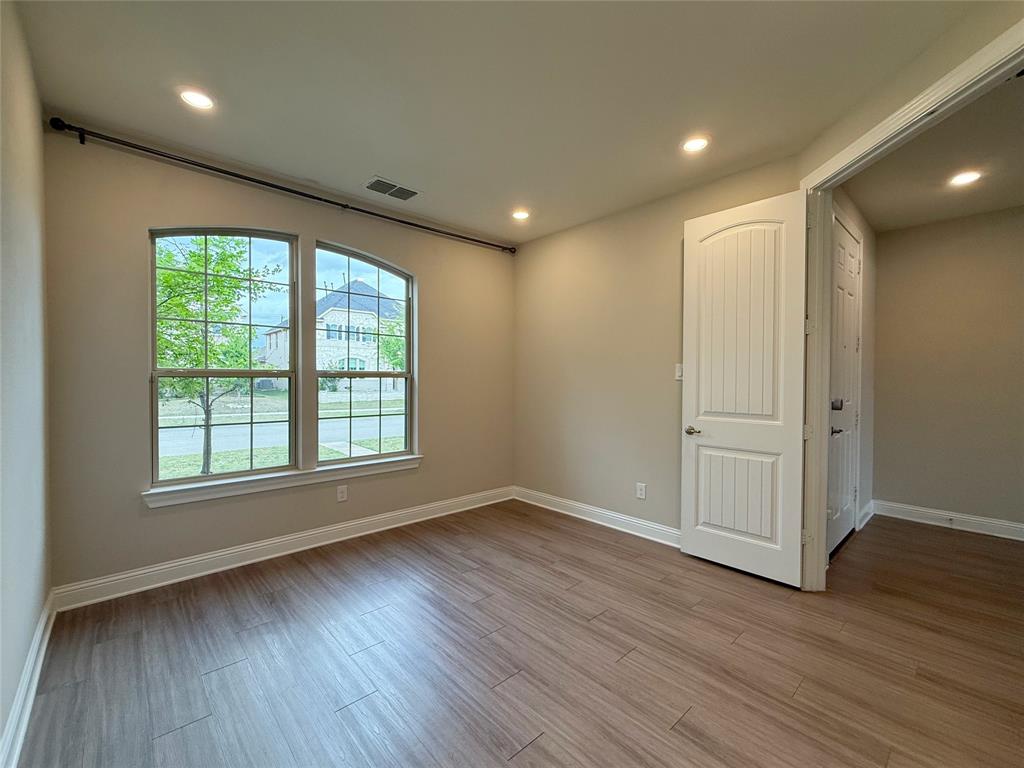9829 Sharps Road Frisco, TX 75035 - Photo 3 of 40 Unfurnished room with recessed lighting and light wood finished floors