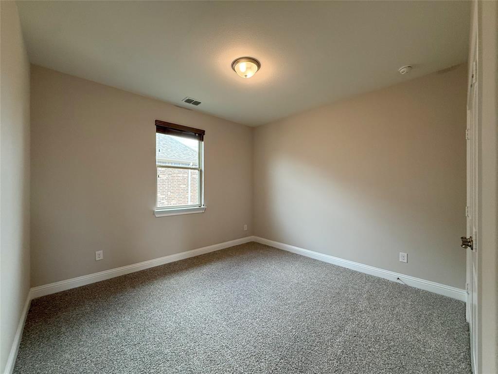 9829 Sharps Road Frisco, TX 75035 - Photo 28 of 40 Spare room featuring light carpet and baseboards