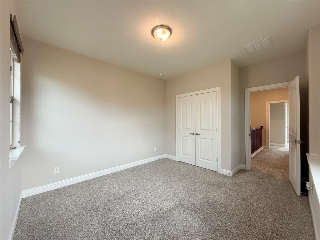 9829 Sharps Road Frisco, TX 75035 - Photo 32 of 40 Unfurnished bedroom with carpet floors and a closet