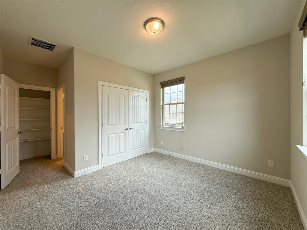 9829 Sharps Road Frisco, TX 75035 - Photo 33 of 40 Unfurnished bedroom featuring light colored carpet and a closet