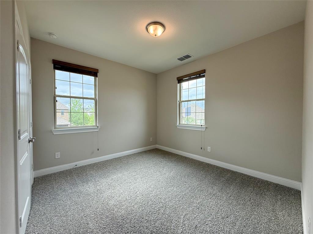 9829 Sharps Road Frisco, TX 75035 - Photo 34 of 40 Unfurnished room featuring baseboards and light colored carpet