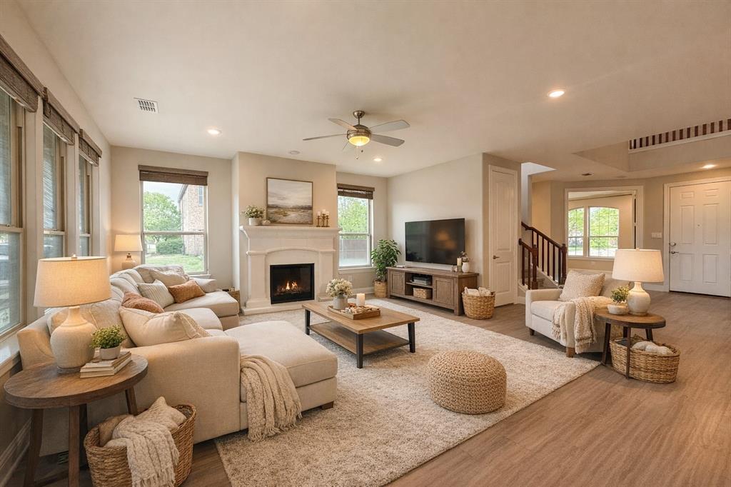 9829 Sharps Road Frisco, TX 75035 - Photo 7 of 40 Living room with wood finished floors, a lit fireplace, ceiling fan, and recessed lighting