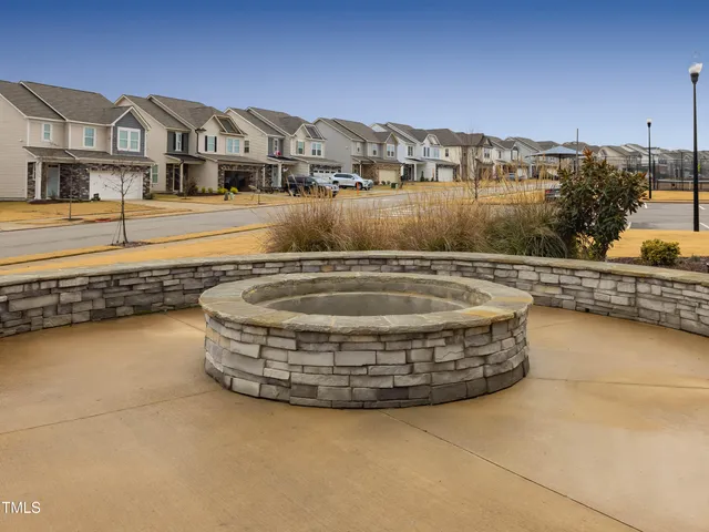 a view of a white house with a big yard next to a road