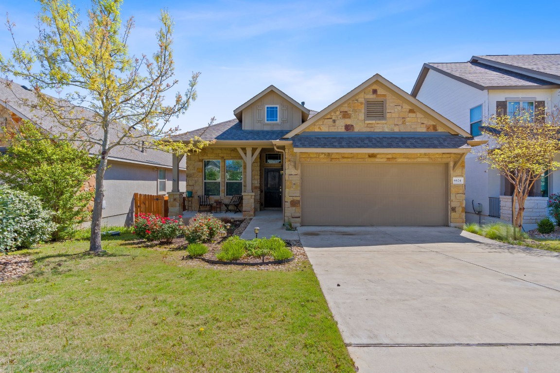 6624 Llano Stage Trail Austin, TX 78738 - Photo 1 of 1 a front view of a house with a yard and garage
