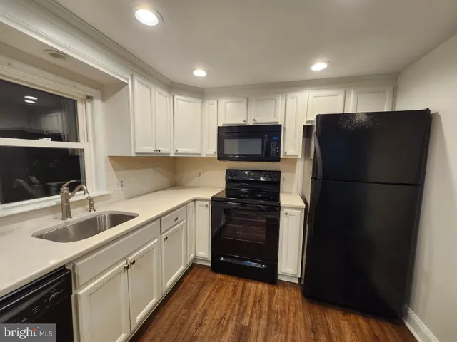 a kitchen with a refrigerator and a sink