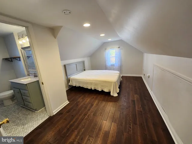 a bedroom with a bed and a mirror