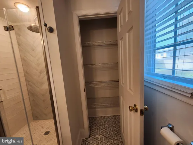a bathroom with a glass door shower and a sink