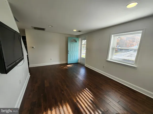 a view of room with window and wooden floor