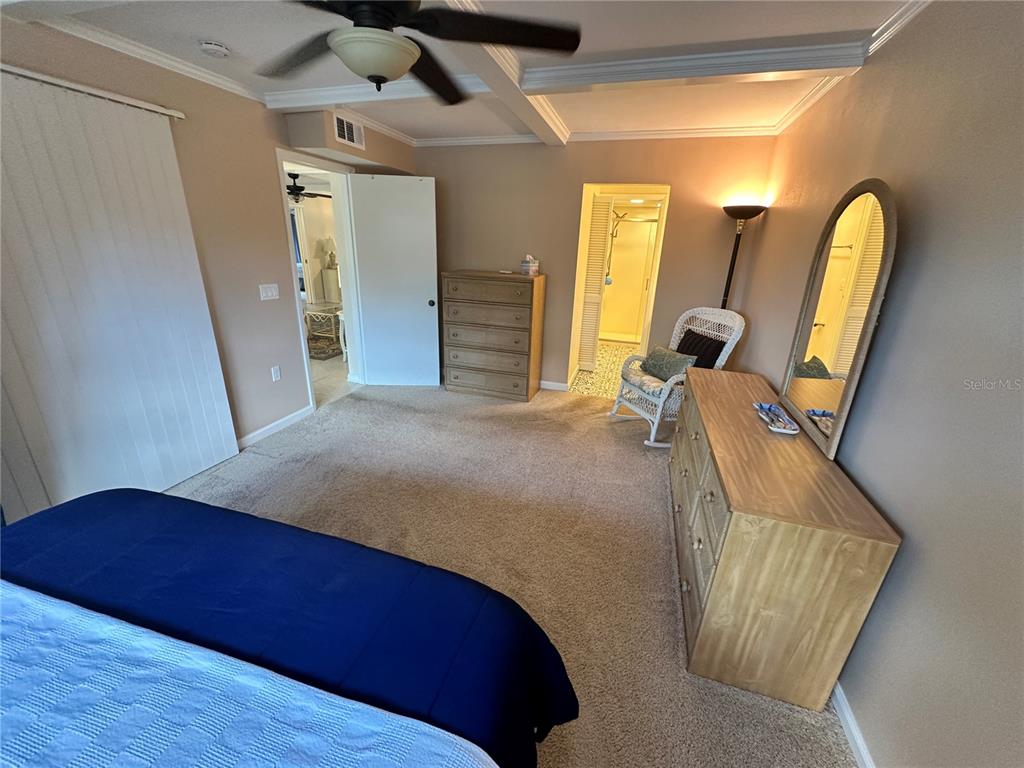 4572 Red Maple, Unit 901 Bradenton, FL 34210 - Photo 12 of 30 a bedroom with a bed and wooden floor