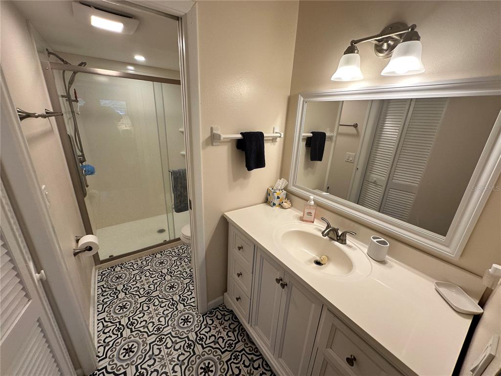 4572 Red Maple, Unit 901 Bradenton, FL 34210 - Photo 13 of 30 a bathroom with a sink a toilet a mirror and shower