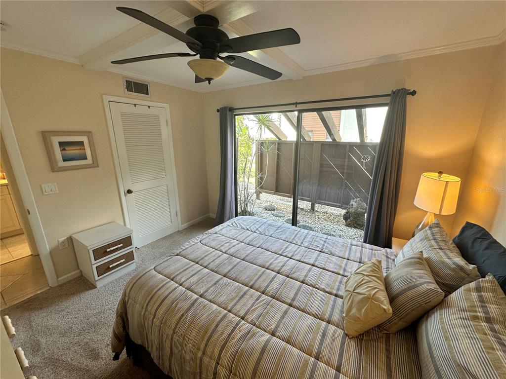 4572 Red Maple, Unit 901 Bradenton, FL 34210 - Photo 16 of 30 a bedroom with a bed and wooden floor