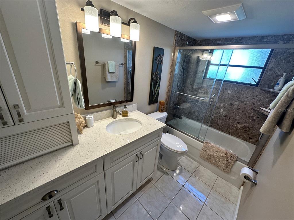 4572 Red Maple, Unit 901 Bradenton, FL 34210 - Photo 17 of 30 a bathroom with a double vanity sink toilet mirror and window