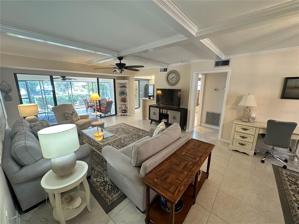 4572 Red Maple, Unit 901 Bradenton, FL 34210 - Photo 2 of 30 a living room with furniture and a flat screen tv