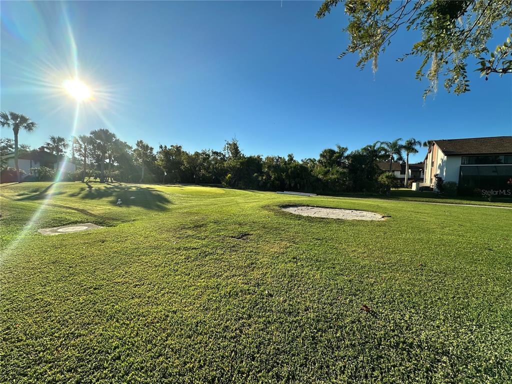 4572 Red Maple, Unit 901 Bradenton, FL 34210 - Photo 23 of 30 a view of a golf course with a lake