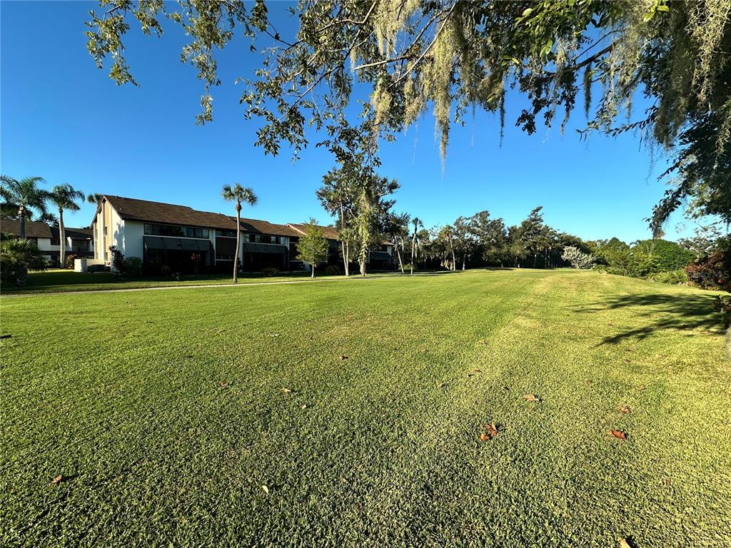 4572 Red Maple, Unit 901 Bradenton, FL 34210 - Photo 24 of 30 a view of a field of grass and trees