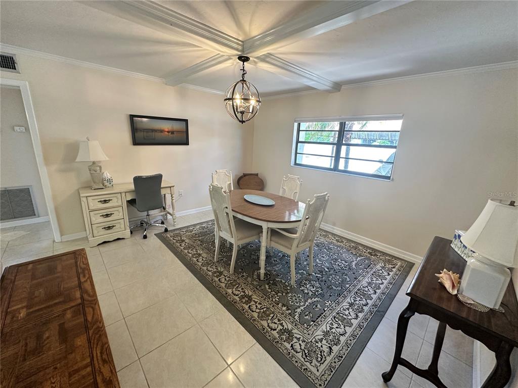 4572 Red Maple, Unit 901 Bradenton, FL 34210 - Photo 3 of 30 a dining room with a table and chairs