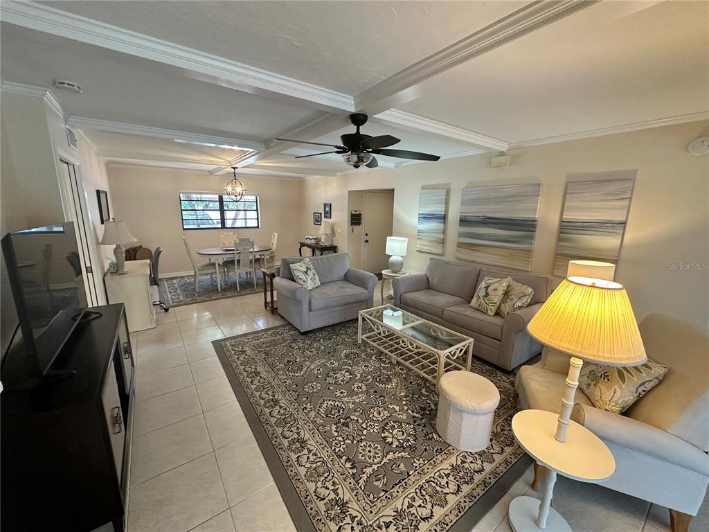 4572 Red Maple, Unit 901 Bradenton, FL 34210 - Photo 5 of 30 a living room with furniture and a lamp