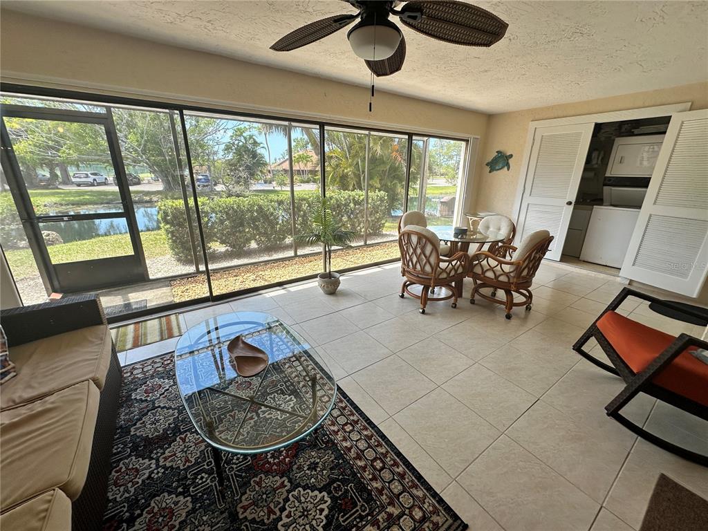 4572 Red Maple, Unit 901 Bradenton, FL 34210 - Photo 6 of 30 a living room with furniture and a floor to ceiling window