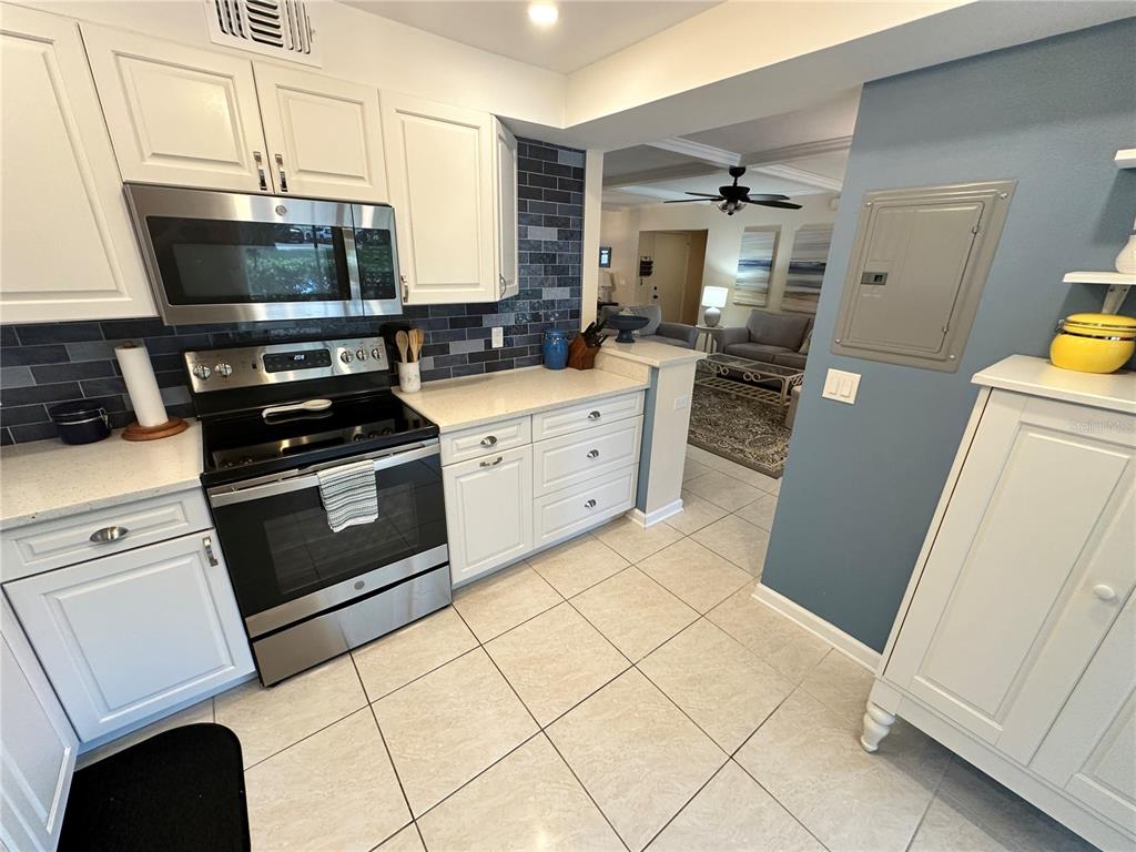4572 Red Maple, Unit 901 Bradenton, FL 34210 - Photo 8 of 30 a kitchen with a stove a sink and a microwave