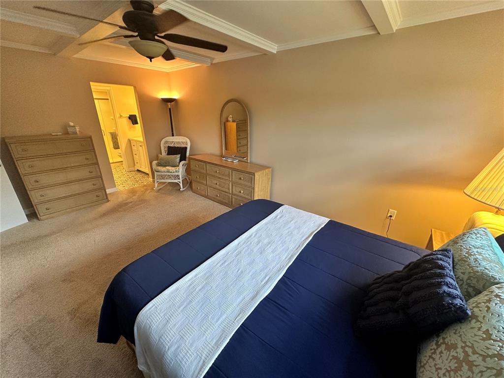 4572 Red Maple, Unit 901 Bradenton, FL 34210 - Photo 10 of 30 a bed sitting in a bedroom next to a larger window