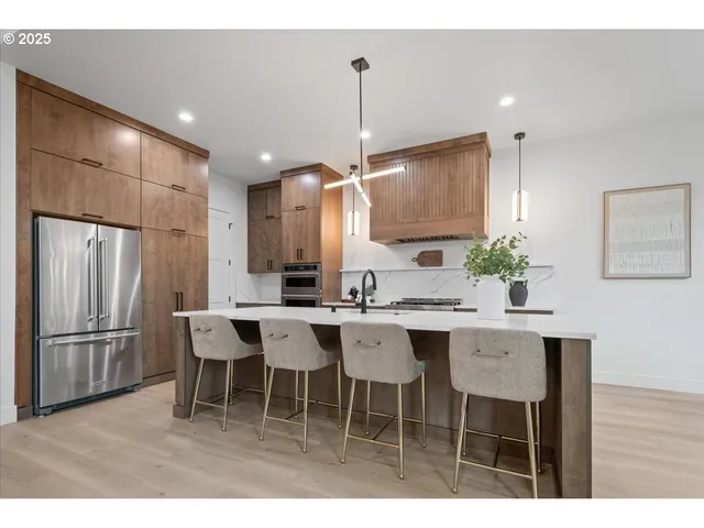 a kitchen with a dining table chairs sink and cabinets
